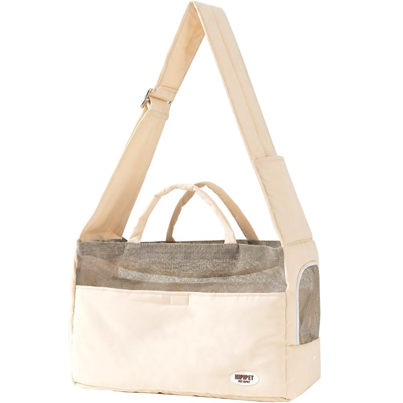 Cream pet sling bag with adjustable shoulder strap and mesh panels